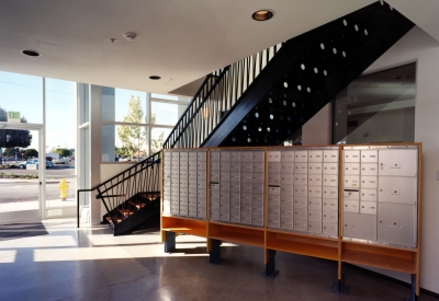Entry lobby with mailboxes and stairs at Pensione Esperanza in San Jose, California. 