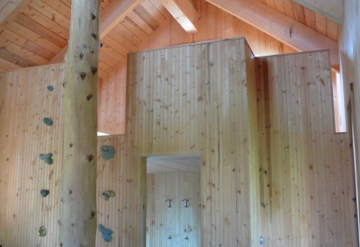 Interior view of Redstone Cabin with a rock climbing wall to get to the upstairs loft in Redstone Colorado.