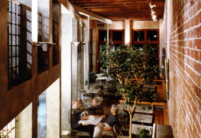 Interior view of Cafe Milano from the second level with four men having coffee in Berkeley, California.