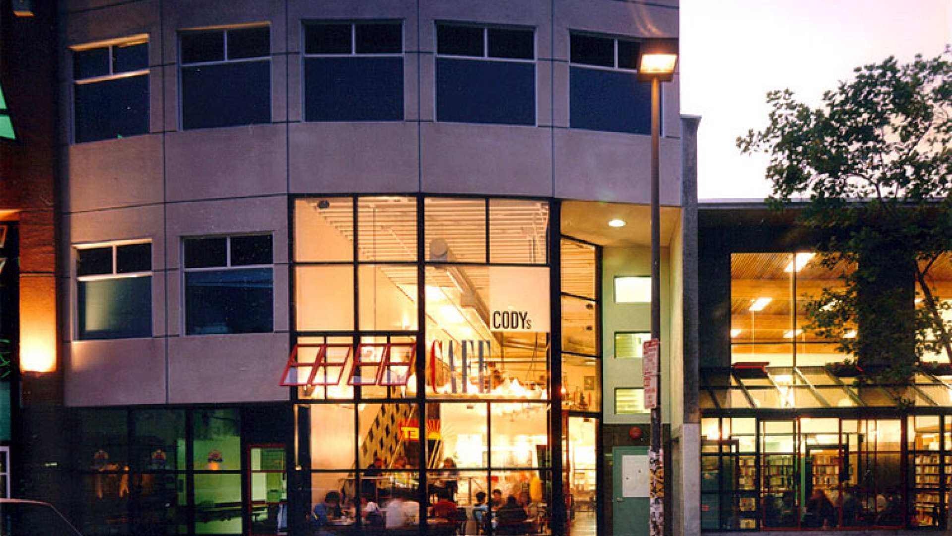 Exterior street view of  Fred Cody Building & Cody's Cafe at dusk in Berkeley, California.