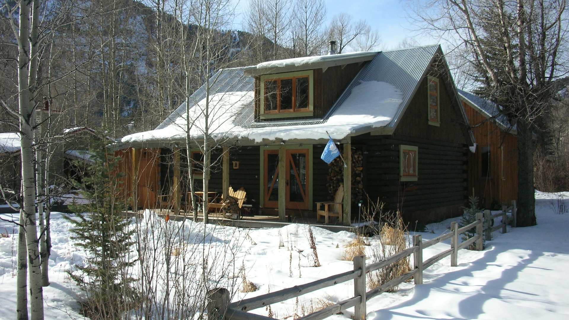 Exterior view of the Redstone Cabin covered in snow in Redstone Colorado.