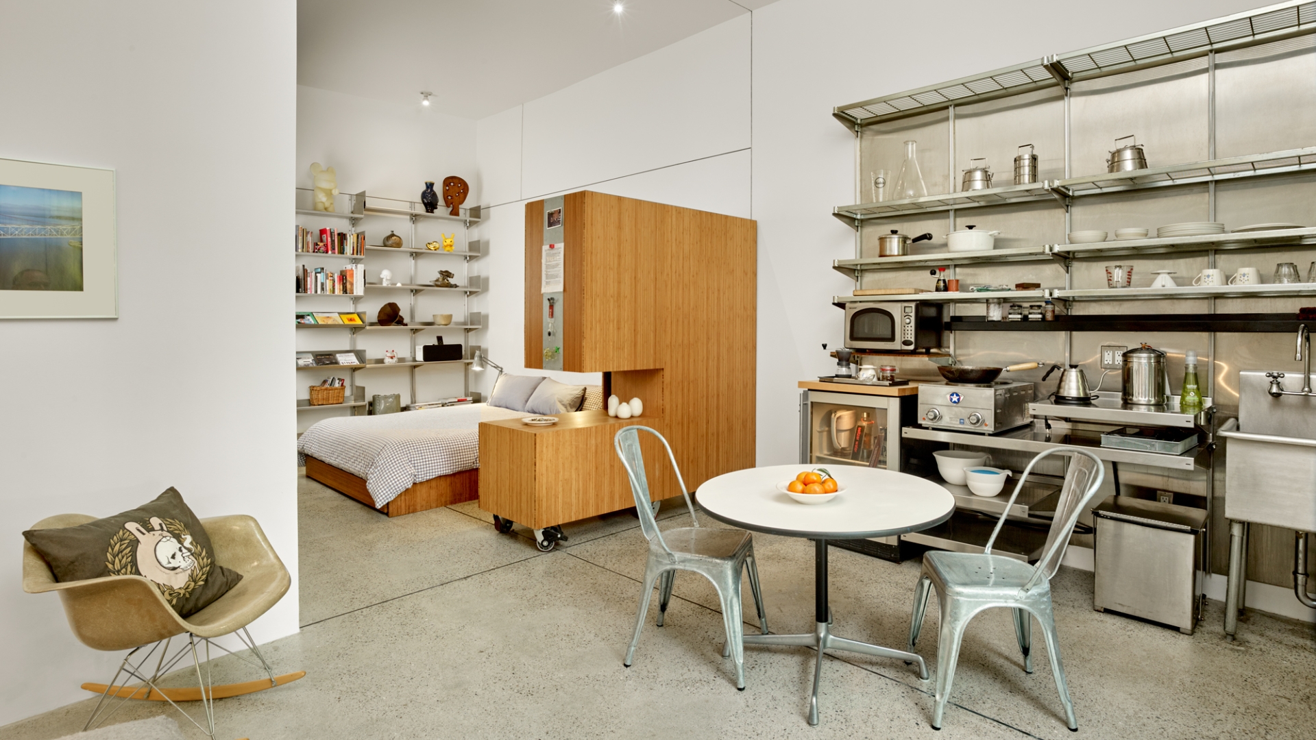 Interior view of the kitchen and dining area with sleeping area in the background in Shotwell Garden Retreat in San Francisco.