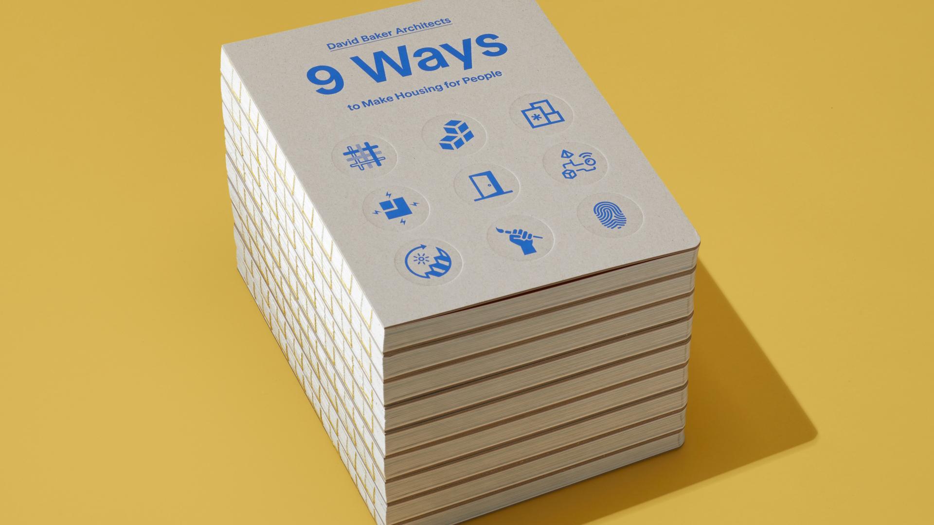 Stack of DBA's new book 9 Ways to Make Housing for People on a bright yellow background.