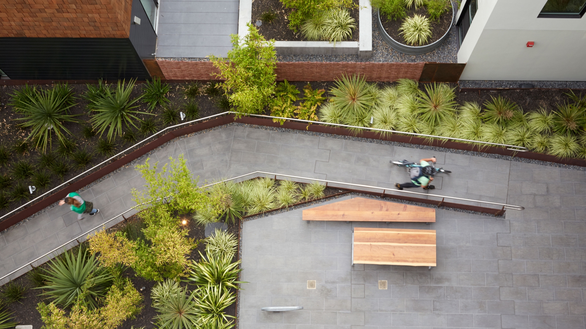 Aerial view of the courtyard with someone walking along a green path at 300 Ivy in San Francisco.