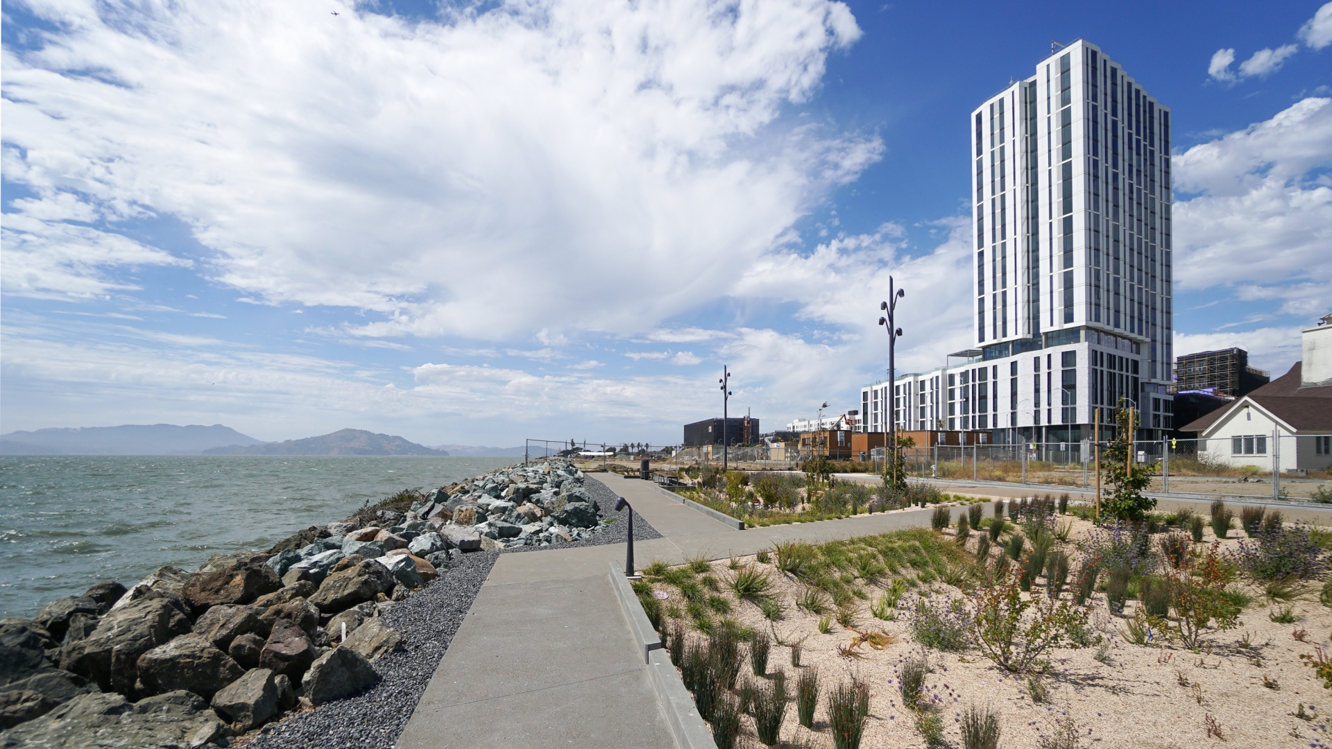 Exterior view of Isle House on Treasure Island with the San Francisco bay in the background.