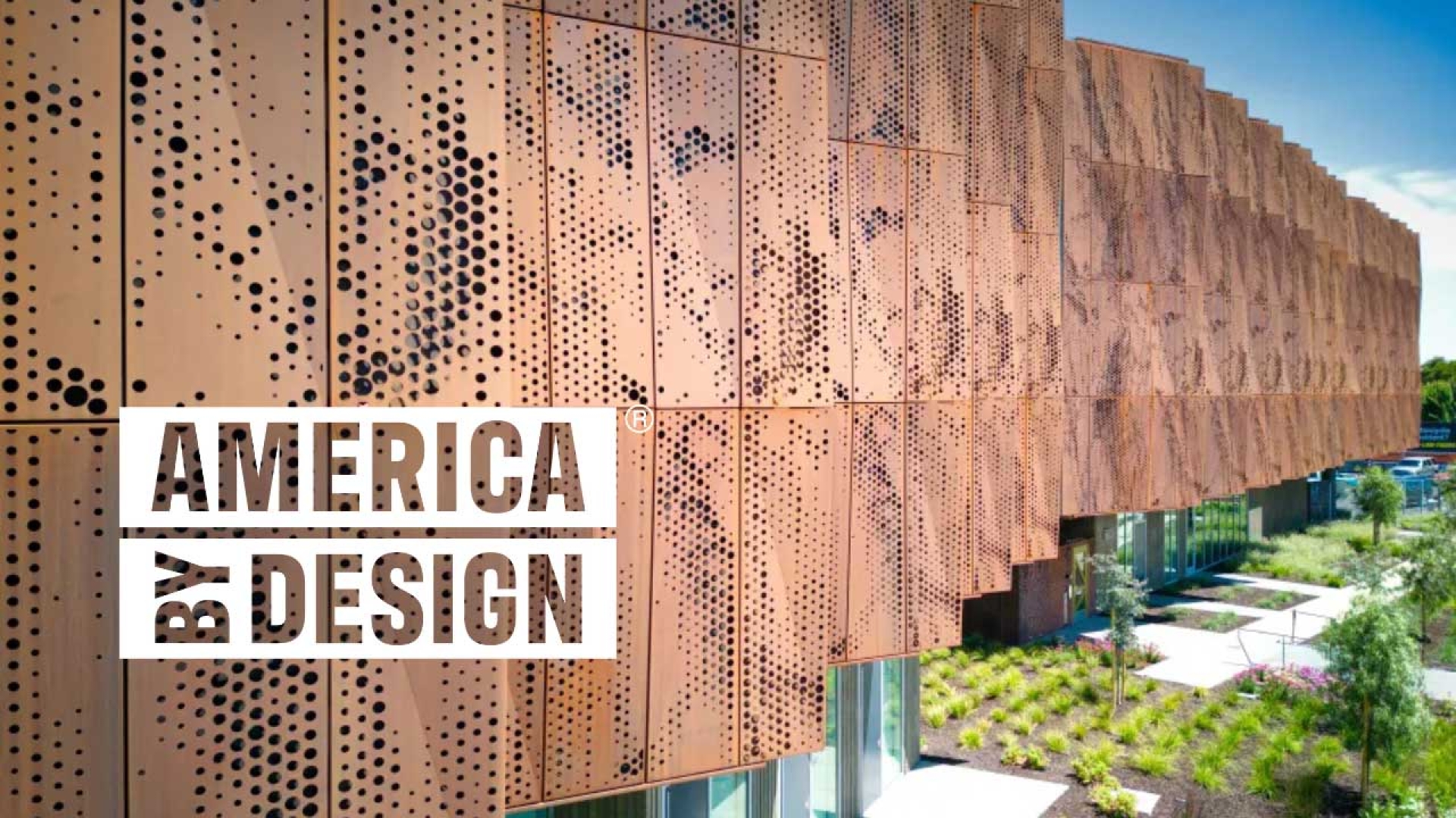 Detail of a multifamily building clad in weathered steel, with an overlaid logo reading "America By Design"