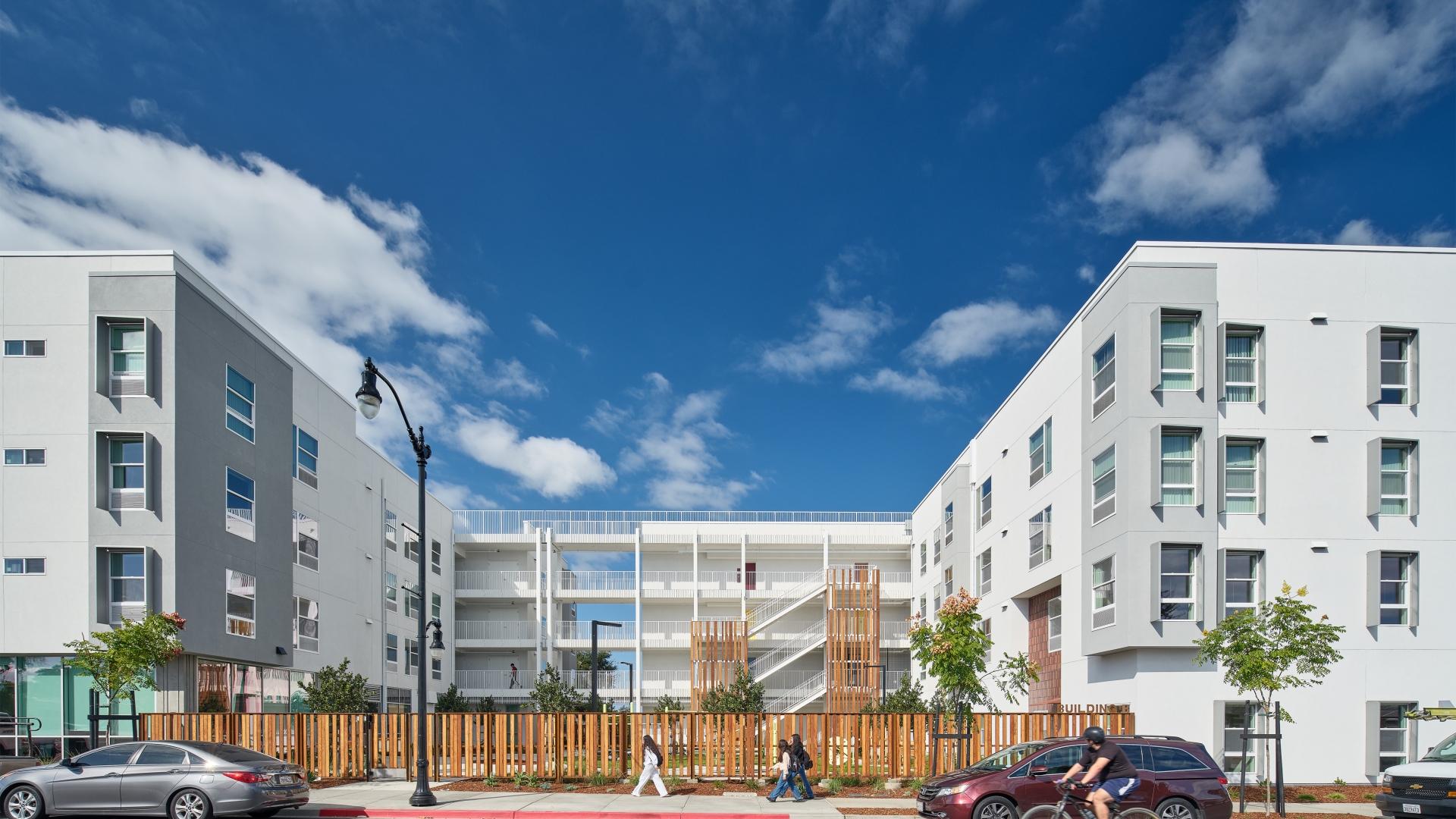 Image of a courtyard and open-air circulation linking two wings of a large white building