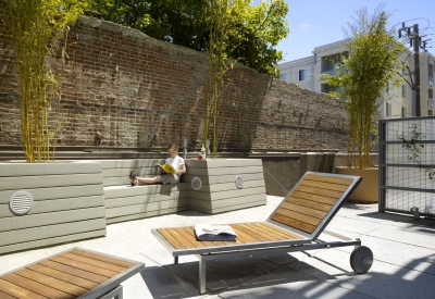 Person siting in the shared courtyard at 200 Second Street in Oakland, California.