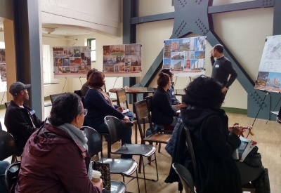 Community members sitting down at a meeting for 34th and San Pablo Affordable Family Housing in Oakland, California.