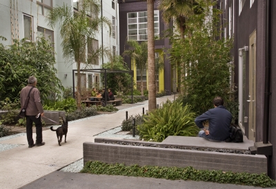 People hanging in a courtyard at Pacific Cannery Lofts in Oakland, California.