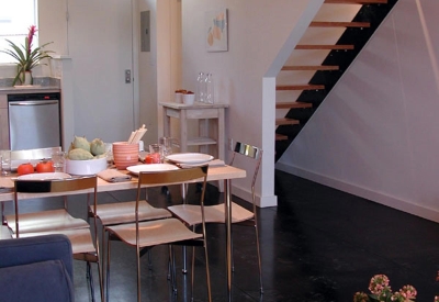 Ground level kitchen and living area inside a unit at Magnolia Row in West Oakland, California.