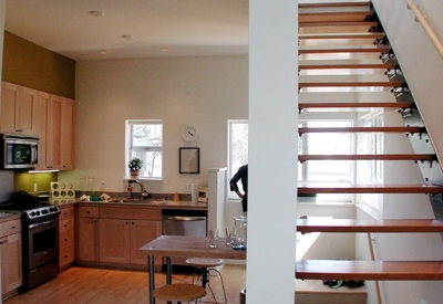 Stairs above the kitchen in a unit at Magnolia Row in West Oakland, California.