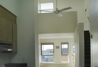 Kitchen and living area inside a unit at Folsom-Dore Supportive Apartments in San Francisco, California.