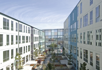 Residential courtyard with glass sound wall at 888 Seventh Street in San Francisco.