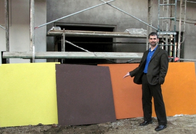 Man standing with the fabric wall colors for Armstrong Place Senior in San Francisco.