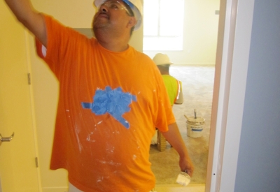 Man painting a unit at Armstrong Place Senior in San Francisco.