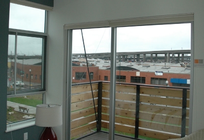 Bedroom and private balcony inside a townhome at West End Commons in Oakland, Ca.