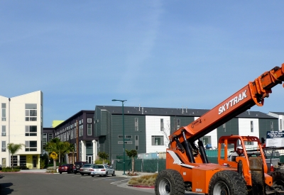 Blue skies with Pacific Cannery Lofts in Oakland, California in the distance.