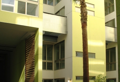 View of the two-story yellow resident building at Pacific Cannery Lofts in Oakland, California.