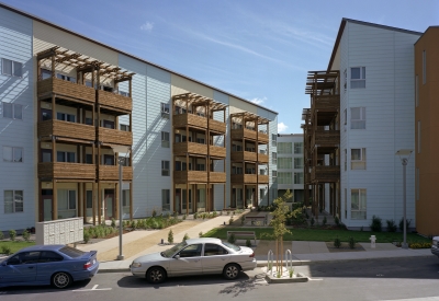 View of the residential courtyard at Crescent Cove from the curved street in San Francisco.