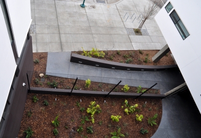 View of the entry court from above at Ironhorse at Central Station in Oakland, California.