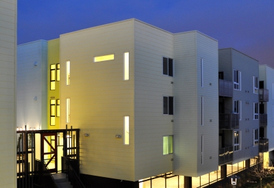 Exterior view at dusk of the pedestrian mews at Ironhorse at Central Station in Oakland, California.