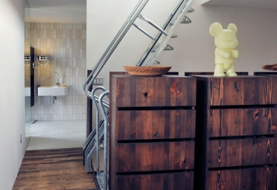 Interior view of sleeping loft area with the bathroom in the background on the third level.