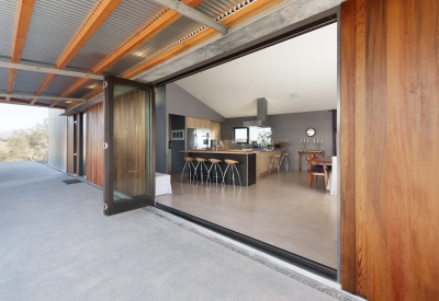 Looking into the kitchen at Healdsburg Rural House from the large open glass door in Healdsburg, California.