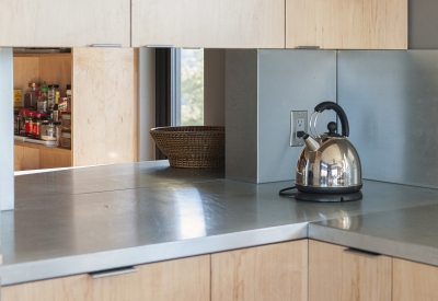 Kitchen detail of the wood cabinets with a peak into the pantry in the background at Healdsburg Rural House in Healdsburg, California.