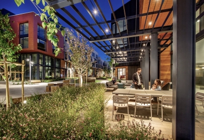 Exterior of leasing office with patio at dusk at Mason on Mariposa in San Francisco.