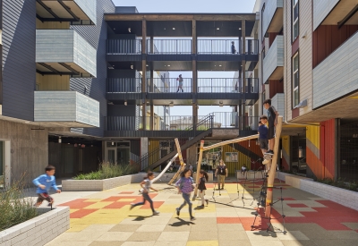 Children playing in the courtyard playground in Edwina Benner Plaza in Sunnyvale, Ca.