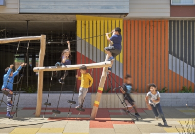 Children playing in the courtyard playground in Edwina Benner Plaza in Sunnyvale, Ca.