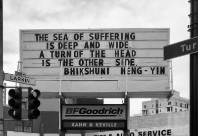 Sign at previous 555 Larkin location that states "The Sea of suffering is deep and wide. A turn of the head is the other side. - Bhikshuni Heng-Yin"