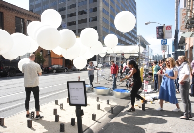 Firm next to Wishing Cloud had the same white balloons but staying in place with string.