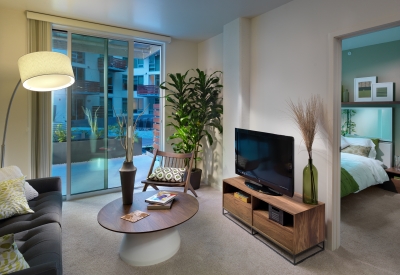 Interior view of a unit living room and bedroom at Rincon Green in San Francisco.