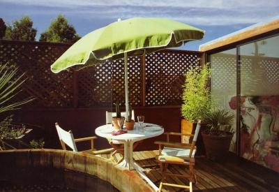 Outdoor umbrella and seating area on the deck of Spaghetti House in Berkeley, California.