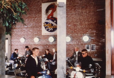 Interior view of Cafe Milano with customers sitting with their mopeds in Berkeley, California.