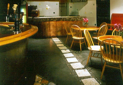 Downstairs bar and tables and chairs at Bison Building & Brew Pub in Berkeley, California.