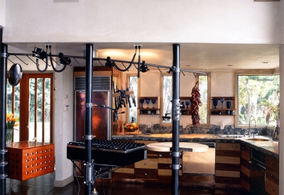 View of the kitchen from the living room inside of Revenge of the Stuccoids in Berkeley, California.