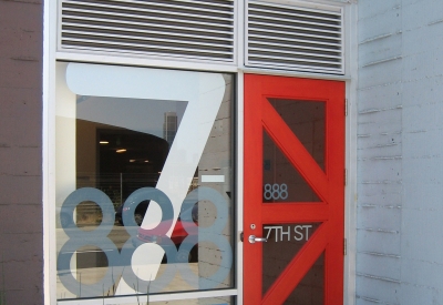 Entry signage and red K door at 888 Seventh Street in San Francisco.