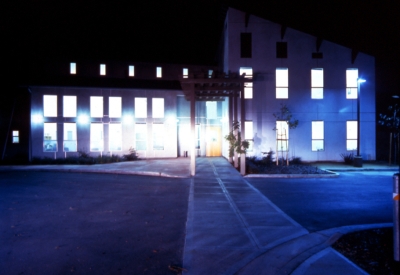 Exterior view of Sunrise Village at night with lights illuminated from the windows in Fremont, California.