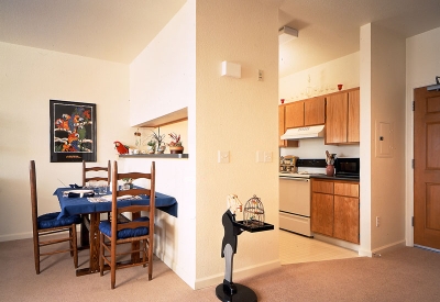 Interior view of dining room and kitchen unit at Plaza Maria in San Jose, California.