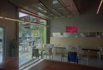 Cafe seating inside and spilling out the courtyard of Taxi 2 in Denver, Colorado. 