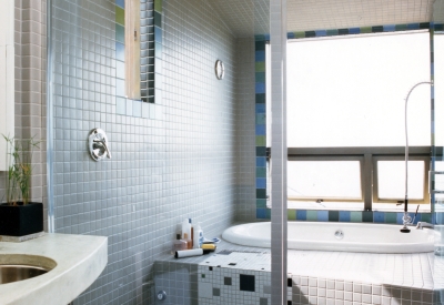 White tile shower and tub inside of Kayo House in Oakland, California.