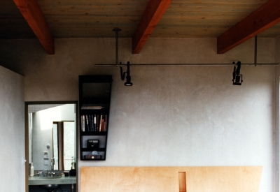 Bedroom with wood headboard inside Kayo House in Oakland, California.