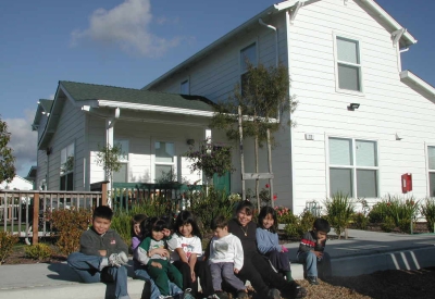 Children sitting at Moonridge Village in Santa Cruz, California.