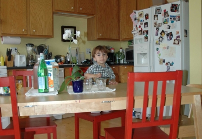 Toddler sits a his kitchen table inside a unit at Bell Mews in San Francisco. 