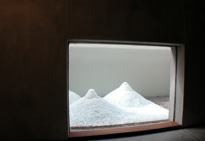 Looking through a window to an art installation small white mountains at 310 Waverly Residence in Palo Alto, California.