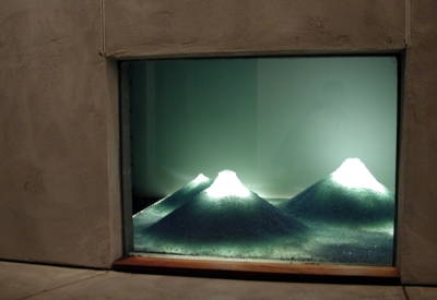 Looking through a window to an art installation small white mountains at 310 Waverly Residence in Palo Alto, California.