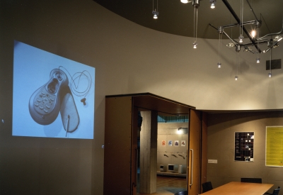 View of the conference room with a project and long conference room table at Frogdesign Studio in San Francisco. 